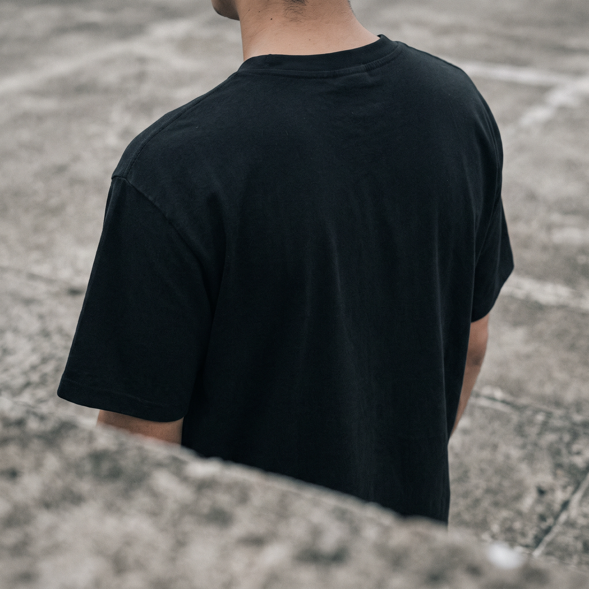 Rider in a black AFS heavyweight tee on raw concrete
